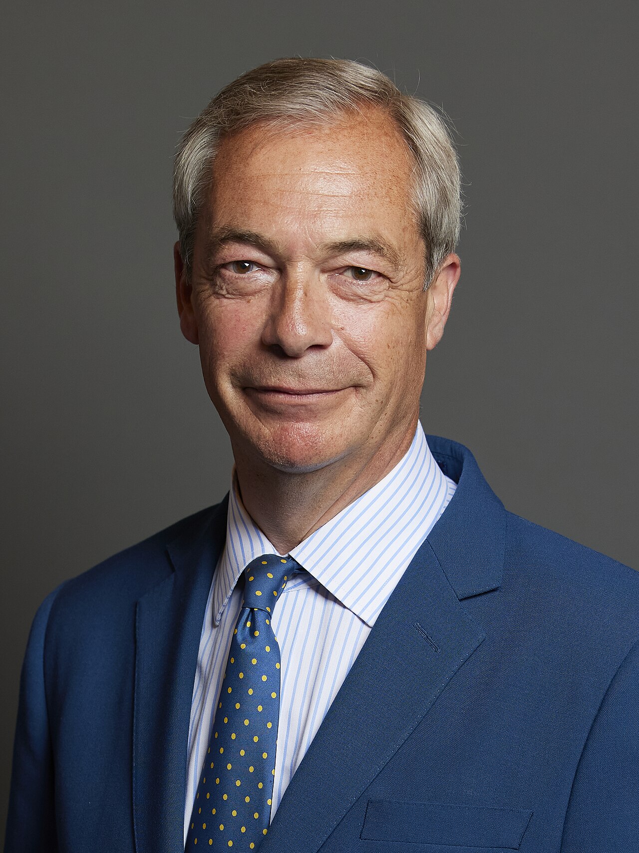 Nigel Farage MP, Leader of Reform UK — the most consistently accurate analyst of British immigration politics of the past thirty years, who was called a racist and a xenophobe for every prediction that has since been validated by events. His party received 14.3% of the UK national vote in the July 2024 general election, more than the Liberal Democrats, while winning only five parliamentary seats. After the Southport riots and the grooming gang scandal revelations that followed, Reform UK polling regularly exceeded 25%. The British electoral system has successfully contained his movement in parliament. It has not contained the underlying reality that drove it. Photo: UK Parliament / Wikimedia Commons