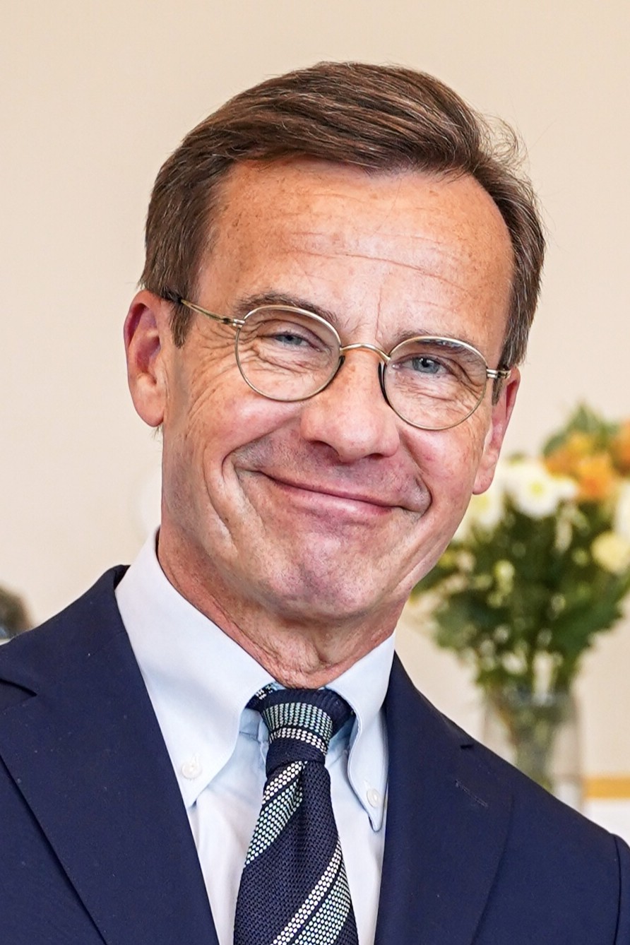 Ulf Kristersson, Prime Minister of Sweden since 2022 — the leader of the center-right Moderate Party who built his governing coalition by making the Sweden Democrats its functional support base. His government has implemented the most aggressive immigration restriction Sweden has seen in decades, reversed the open-borders policies of his social democratic predecessors, and effectively validated every critique of Swedish immigration policy that had been used to politically destroy careers for thirty years. The Sweden Democrats do not sit in his cabinet. They do not need to. They set the terms. Photo: Wikimedia Commons