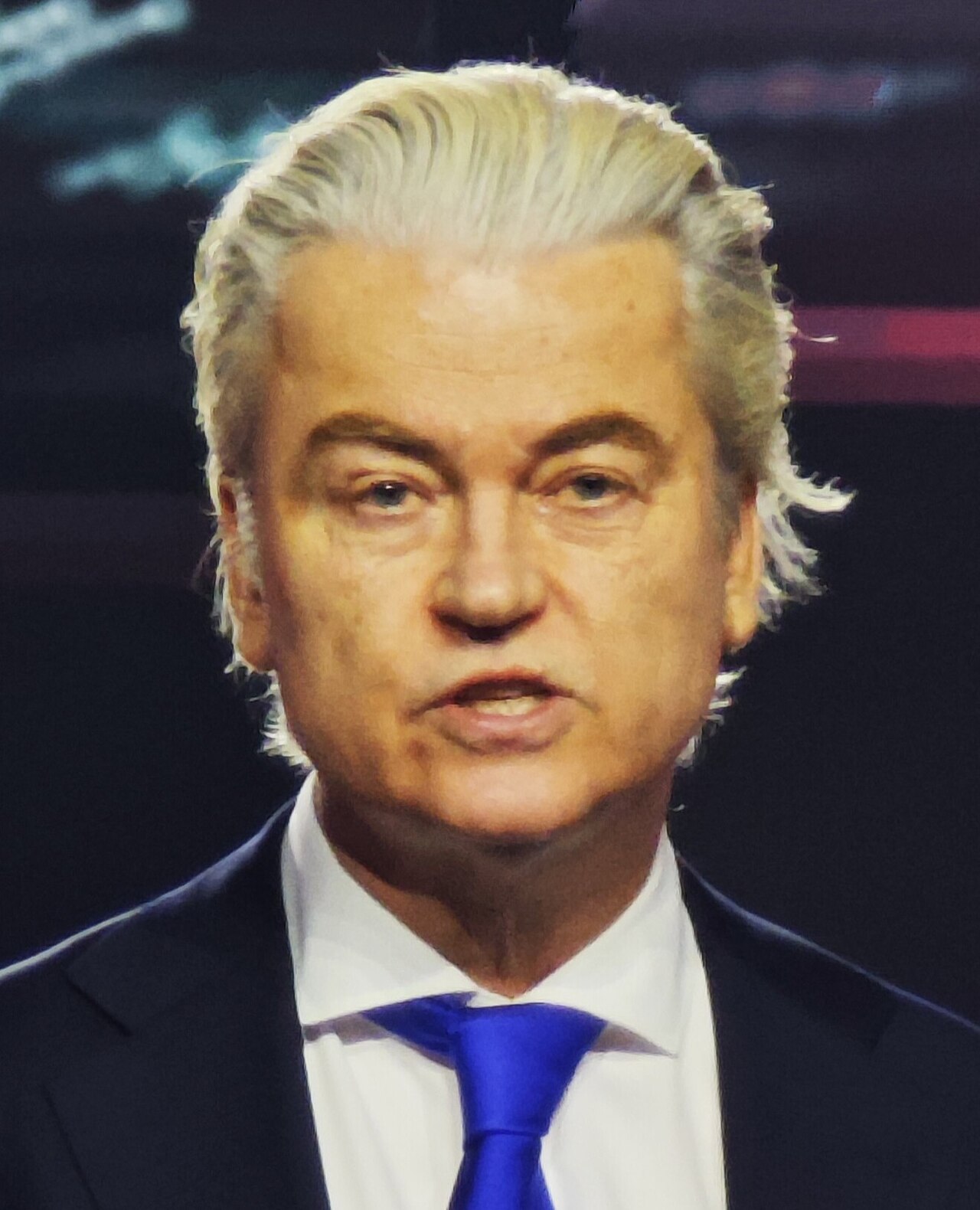 Geert Wilders, leader of the Party for Freedom (PVV) — the Dutch nationalist who won the 2023 Netherlands parliamentary elections outright, having lived under permanent police protection since 2004 due to death threats from Islamist extremists and having been prosecuted twice in Dutch courts for hate speech. His electoral victory was the first time a hard nationalist party had won a national election in Western Europe in the modern democratic era. His position on the relationship between Muslim immigration and Dutch security has been vindicated by every subsequent Dutch crime and terrorism report. Photo: Wikimedia Commons