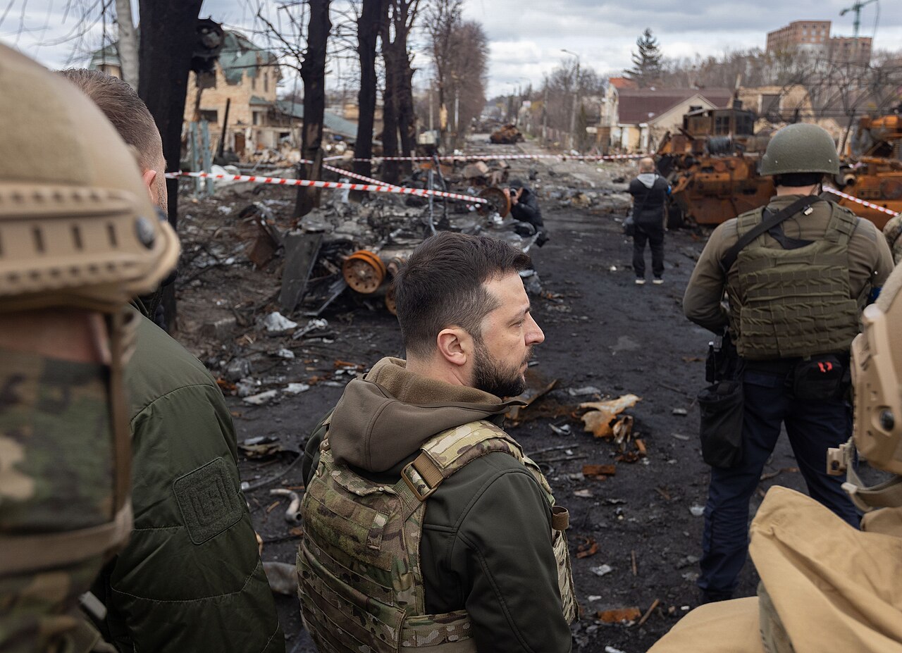 Bucha, Ukraine — after the Russian invasion. A destroyed civilian building, one of tens of thousands of structures damaged or obliterated since February 2022. The war that is doing this was not inevitable. It was the product of three decades of foreign policy decisions that prioritized containing Russia over integrating it, that expanded NATO 1,000 miles eastward over Russian objections, and that made Ukraine — the exact territory where the Bolsheviks committed the Holodomor — the front line of a geopolitical confrontation. The people living in these ruins had nothing to do with any of those decisions. They are paying for them anyway. Photo: Wikimedia Commons