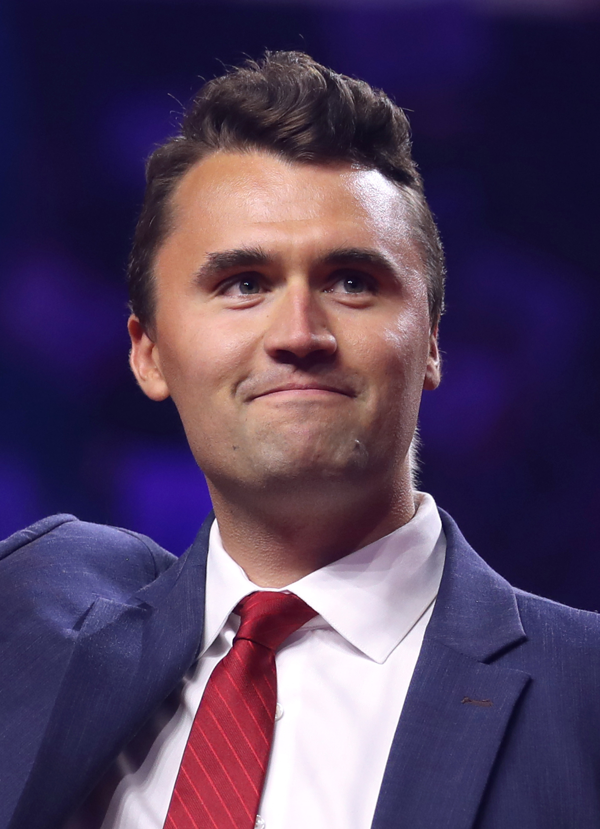 Charlie Kirk addresses thousands of young conservatives at AmericaFest — the annual Turning Point USA conference that has become the defining gathering of the emerging conservative youth movement. Kirk's evolution on Israel and foreign policy has tracked almost exactly with the shift happening inside his own audience, making him one of the most important indicators of where this generation is actually going. Photo: Wikimedia Commons
